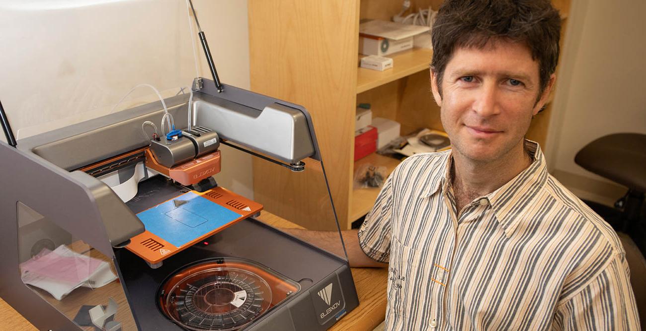 Dr. Mark Yampolskiy, assistant professor in the School of Computing pictured with 3D printing device